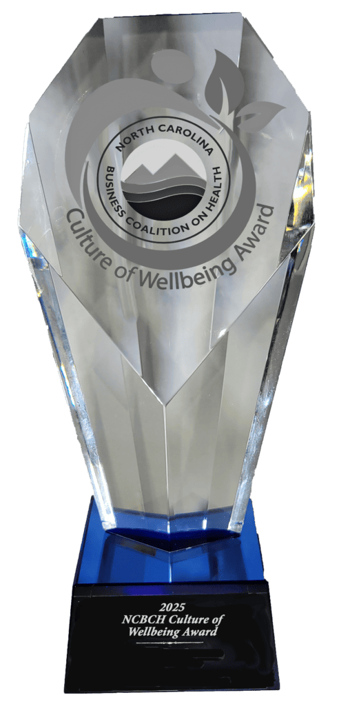 Culture of wellbeing trophy | North Carolina Business Coalition on Health | North Carolina Business Coalition on Health Crystal award trophy with a circular North Carolina Business Coalition on Health Culture of Wellbeing logo and blue base, 2025 section visible on the pedestal.